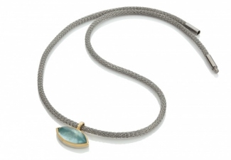 A marquise shaped aquamarine cabochon set in 18ct gold and silver on a knitted steel necklace